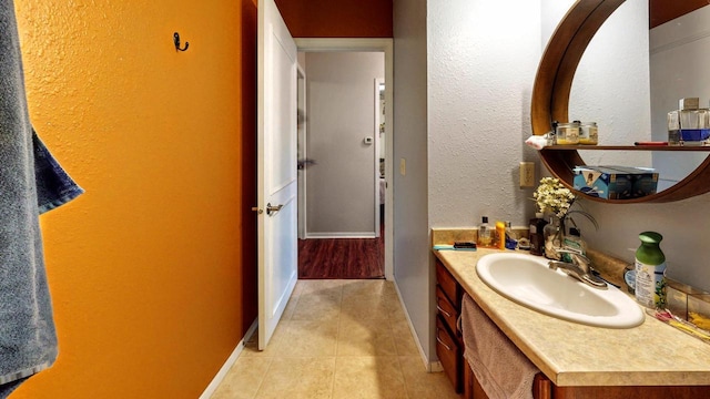 619 Reena Ave Unit 8, Fort Atkinson, WI 53538 - bathroom with tile patterned floors, baseboards, and vanity