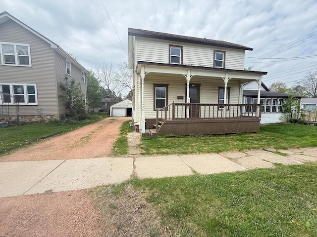 312 W 4th St, Marshfield, WI 54449 - view of front of property with driveway, a porch, an outbuilding, a front lawn, and a garage
