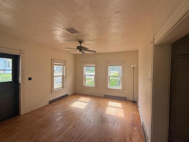 312 W 4th St, Marshfield, WI 54449 - unfurnished room with light wood-type flooring, ceiling fan, baseboards, and a textured ceiling