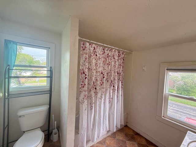 312 W 4th St, Marshfield, WI 54449 - full bath with a shower with curtain, plenty of natural light, and toilet
