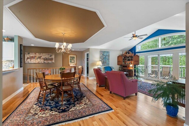 1814 Masters Ln, Madison, WI 53719 - dining room featuring light wood finished floors, a chandelier, a ceiling fan, and vaulted ceiling