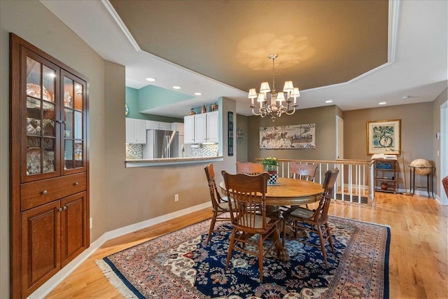 1814 Masters Ln, Madison, WI 53719 - dining room with light wood-style floors, a chandelier, baseboards, recessed lighting, and a tray ceiling