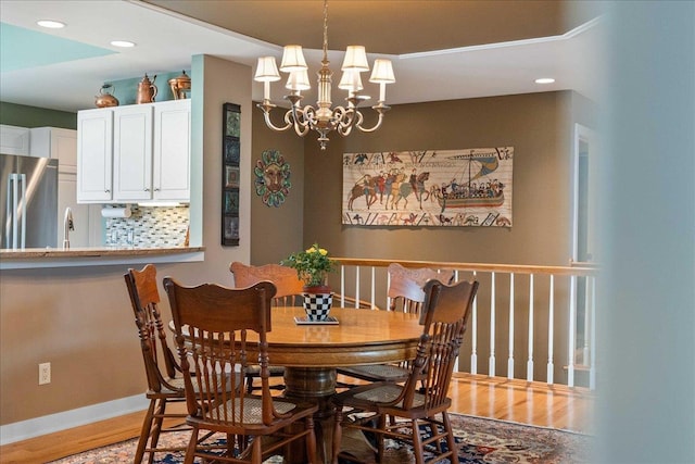 1814 Masters Ln, Madison, WI 53719 - dining room featuring light wood-style floors, a chandelier, baseboards, and recessed lighting