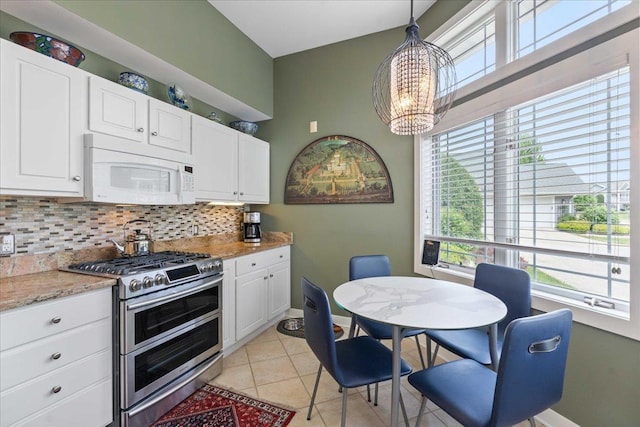 1814 Masters Ln, Madison, WI 53719 - kitchen featuring white microwave, double oven range, decorative backsplash, a chandelier, and white cabinetry