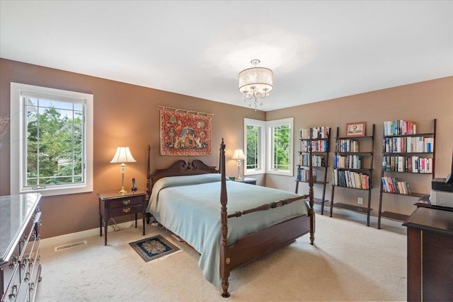 1814 Masters Ln, Madison, WI 53719 - bedroom with light colored carpet, a chandelier, and baseboards