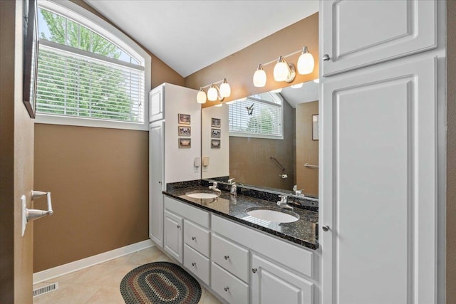 1814 Masters Ln, Madison, WI 53719 - full bath featuring vaulted ceiling, tile patterned flooring, double vanity, and baseboards
