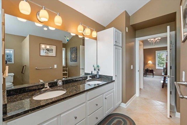 1814 Masters Ln, Madison, WI 53719 - bathroom featuring baseboards, double vanity, toilet, tile patterned floors, and a chandelier