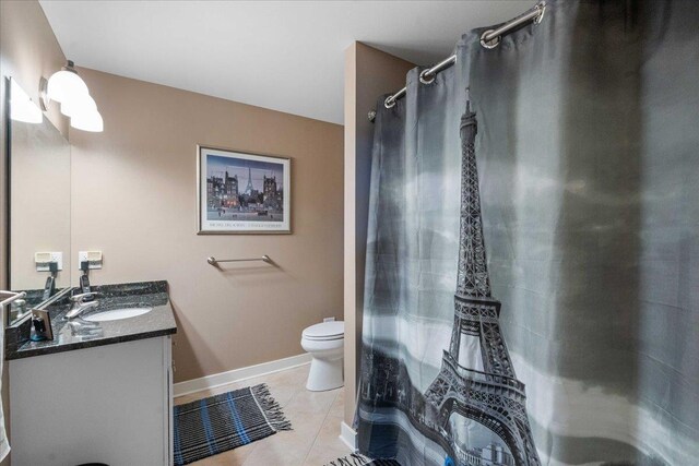 1814 Masters Ln, Madison, WI 53719 - bathroom with baseboards, tile patterned floors, toilet, vanity, and a shower with shower curtain