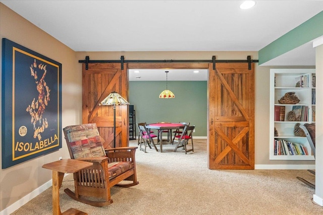 1814 Masters Ln, Madison, WI 53719 - sitting room with a barn door, carpet flooring, built in shelves, baseboards, and recessed lighting