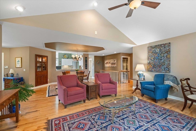 1814 Masters Ln, Madison, WI 53719 - living room with light wood finished floors, a chandelier, ceiling fan, baseboards, and high vaulted ceiling