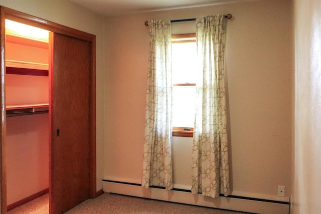 1007 Franklin St, Sauk City, WI 53583 - unfurnished bedroom featuring a closet, a baseboard radiator, and baseboards