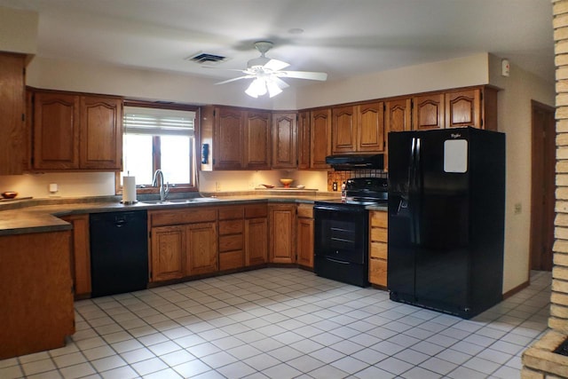 1007 Franklin St, Sauk City, WI 53583 - kitchen featuring black appliances, a sink, under cabinet range hood, and brown cabinetry
