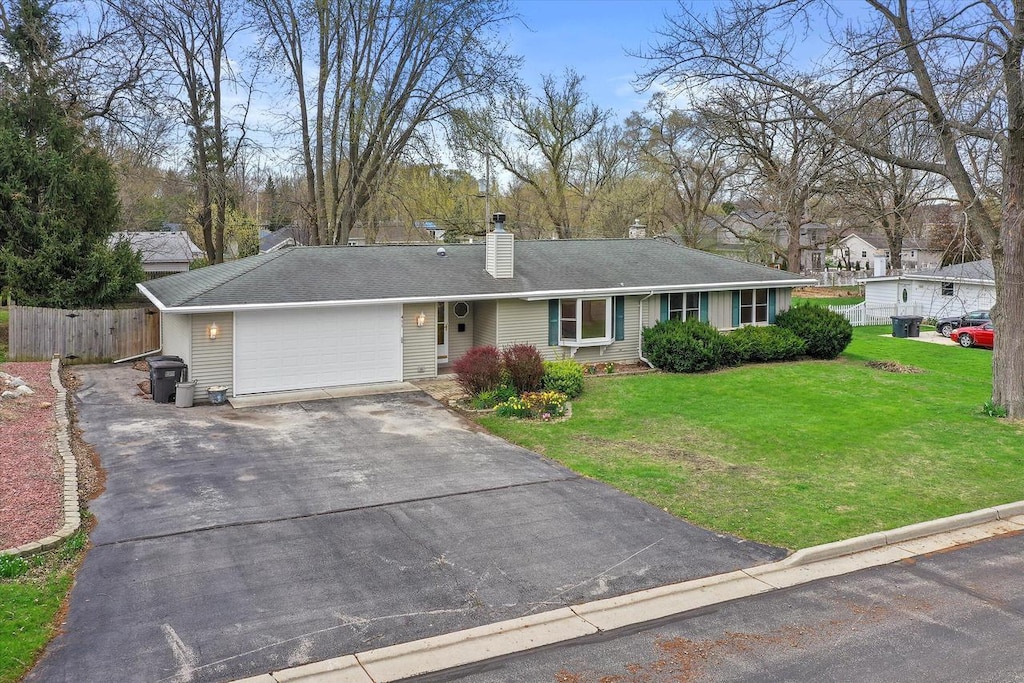 411 Henry St, Mukwonago, WI 53149 - single story home featuring an attached garage, asphalt driveway, and a chimney