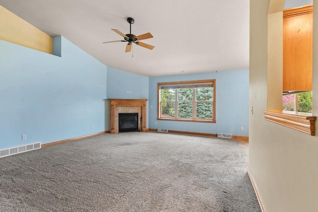 1126 Princess Dove Cir, De Pere, WI 54115 - unfurnished living room featuring carpet flooring, vaulted ceiling, a ceiling fan, baseboards, and a tiled fireplace