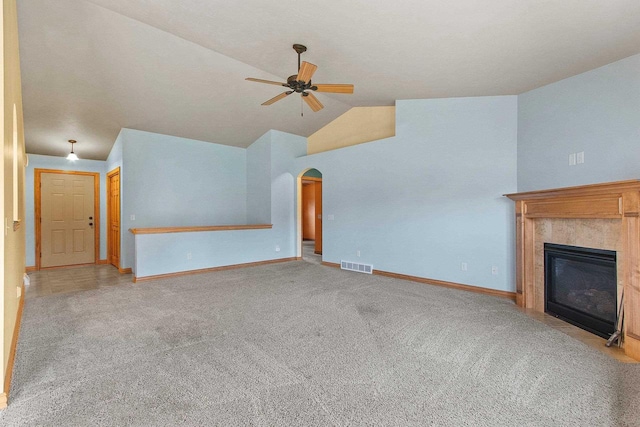 1126 Princess Dove Cir, De Pere, WI 54115 - unfurnished living room featuring a ceiling fan, carpet floors, lofted ceiling, arched walkways, and baseboards