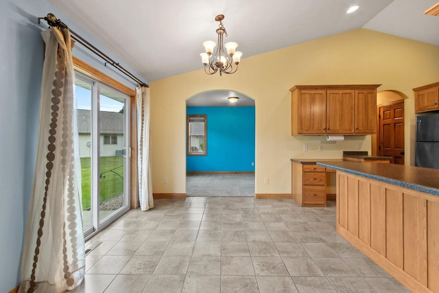 1126 Princess Dove Cir, De Pere, WI 54115 - kitchen with arched walkways, vaulted ceiling, freestanding refrigerator, dark countertops, and a chandelier
