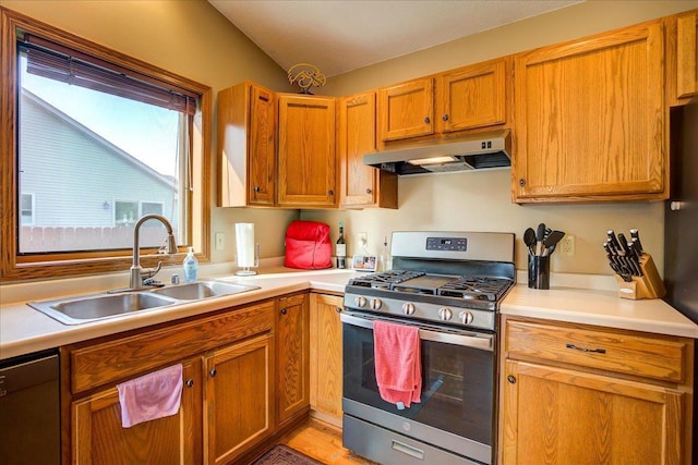 182 Ames St, Oregon, WI 53575 - kitchen with stainless steel appliances, under cabinet range hood, light countertops, a sink, and brown cabinets