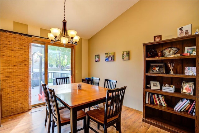 182 Ames St, Oregon, WI 53575 - dining room featuring vaulted ceiling, light wood finished floors, and a chandelier