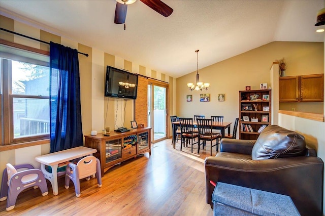 182 Ames St, Oregon, WI 53575 - living area featuring a chandelier, ceiling fan, light wood-style flooring, and vaulted ceiling