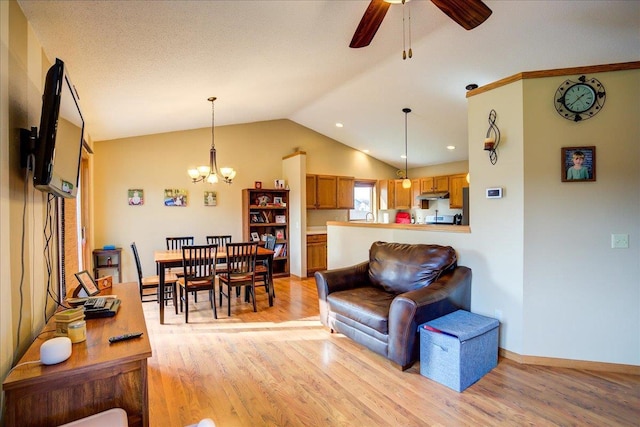 182 Ames St, Oregon, WI 53575 - living area with light wood-type flooring, lofted ceiling, ceiling fan, a chandelier, and baseboards