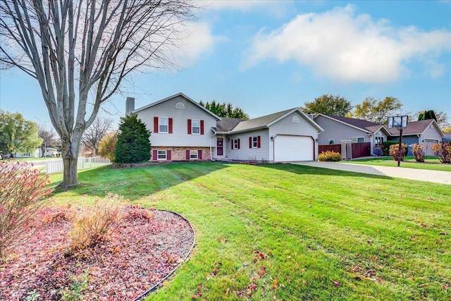 182 Ames St, Oregon, WI 53575 - split level home with concrete driveway, a garage, and a chimney