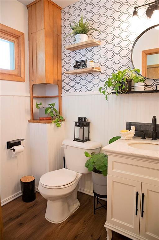 2702 Clark Pl, Eau Claire, WI 54701 - half bathroom featuring wood finished floors, toilet, and vanity