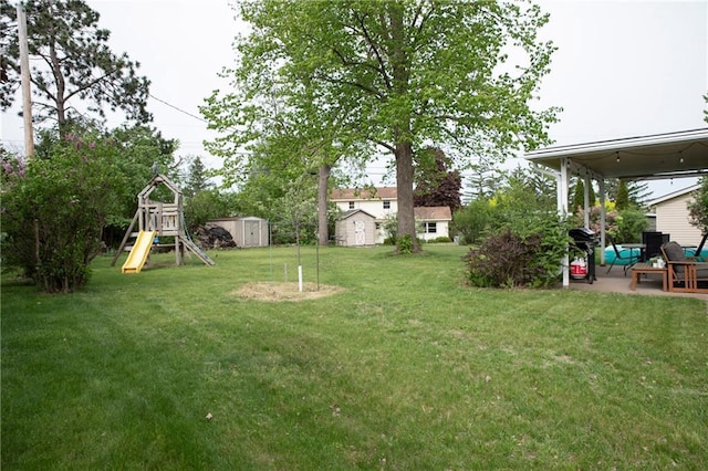 2702 Clark Pl, Eau Claire, WI 54701 - view of green lawn featuring a playground and a patio