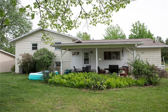 2702 Clark Pl, Eau Claire, WI 54701 - rear view of house with a lawn and covered porch