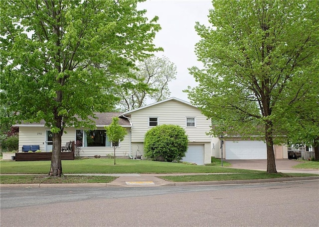 2702 Clark Pl, Eau Claire, WI 54701 - tri-level home featuring driveway, a front lawn, and an attached garage