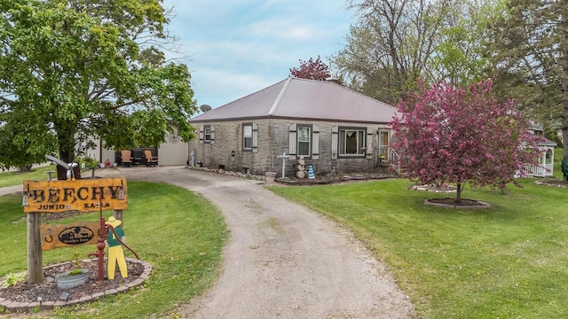 W8749 Hunters Rd, Hortonville, WI 54944 - view of front facade featuring driveway, a front yard, stone siding, and metal roof