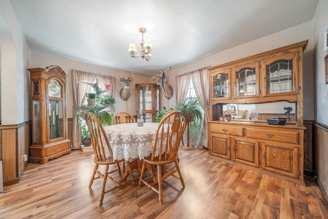 W8749 Hunters Rd, Hortonville, WI 54944 - dining room with a chandelier, a wainscoted wall, and light wood-style flooring