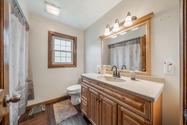 W8749 Hunters Rd, Hortonville, WI 54944 - bathroom featuring baseboards, wood finished floors, toilet, and vanity