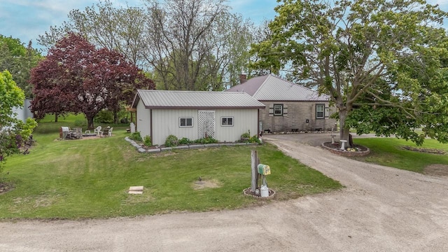 W8749 Hunters Rd, Hortonville, WI 54944 - view of front of home featuring a front lawn, metal roof, and driveway
