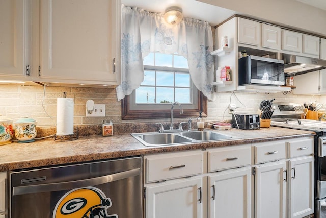 W8749 Hunters Rd, Hortonville, WI 54944 - kitchen with appliances with stainless steel finishes, a sink, under cabinet range hood, white cabinetry, and backsplash