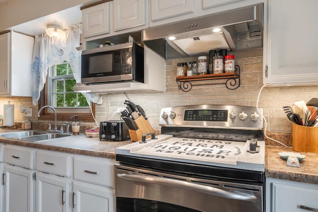 W8749 Hunters Rd, Hortonville, WI 54944 - kitchen featuring appliances with stainless steel finishes, under cabinet range hood, a sink, tasteful backsplash, and white cabinetry