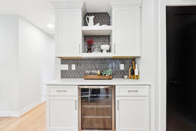 6020 Briarclift Ct, Greendale, WI 53129 - indoor dry bar with wine cooler, decorative backsplash, baseboards, light wood-style floors, and recessed lighting