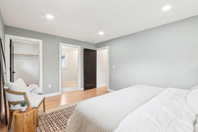 6020 Briarclift Ct, Greendale, WI 53129 - bedroom with light wood-type flooring, recessed lighting, baseboards, a closet, and ensuite bath