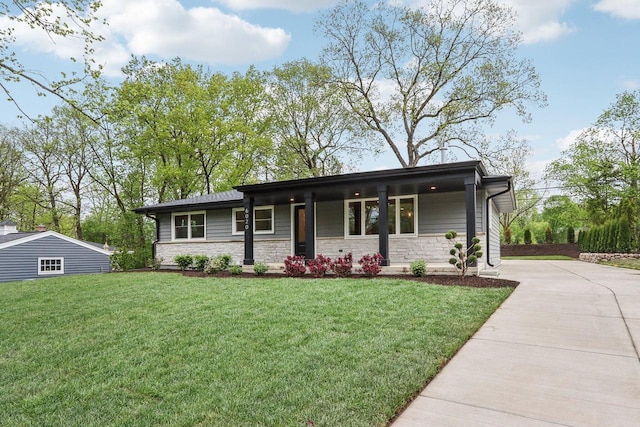 6020 Briarclift Ct, Greendale, WI 53129 - view of front of house with a front lawn, stone siding, covered porch, and concrete driveway