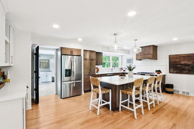 6020 Briarclift Ct, Greendale, WI 53129 - kitchen with stainless steel fridge with ice dispenser, recessed lighting, light countertops, light wood-style floors, and a sink