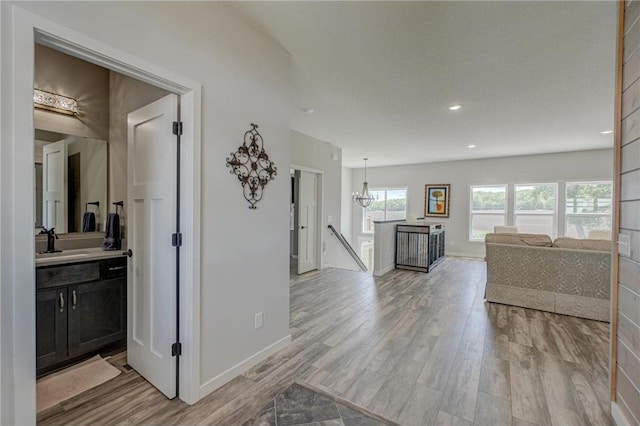 17690 Clayton Ave, Rosemount, MN 55068 - hallway featuring an upstairs landing, a sink, light wood-type flooring, baseboards, and recessed lighting