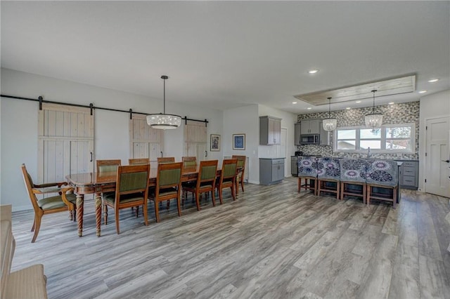 17690 Clayton Ave, Rosemount, MN 55068 - dining area featuring a barn door, light wood finished floors, and recessed lighting