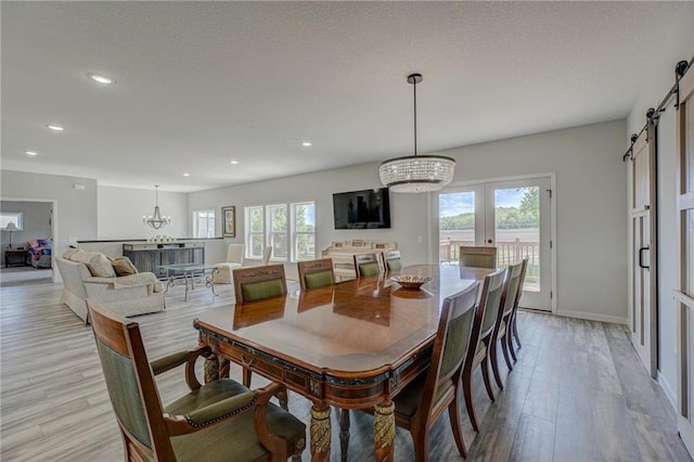 17690 Clayton Ave, Rosemount, MN 55068 - dining room with a chandelier, a barn door, light wood finished floors, recessed lighting, and baseboards
