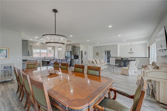 17690 Clayton Ave, Rosemount, MN 55068 - dining room with a chandelier, light wood-style flooring, and recessed lighting