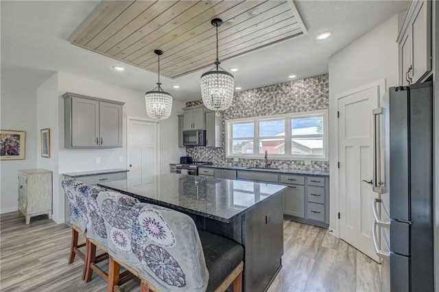 17690 Clayton Ave, Rosemount, MN 55068 - kitchen featuring stainless steel appliances, gray cabinets, a sink, light wood-style floors, and a chandelier