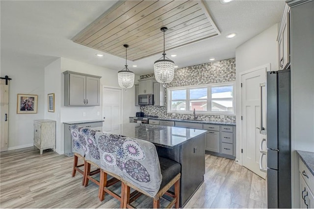 17690 Clayton Ave, Rosemount, MN 55068 - kitchen with freestanding refrigerator, gray cabinetry, a sink, light wood-style flooring, and recessed lighting