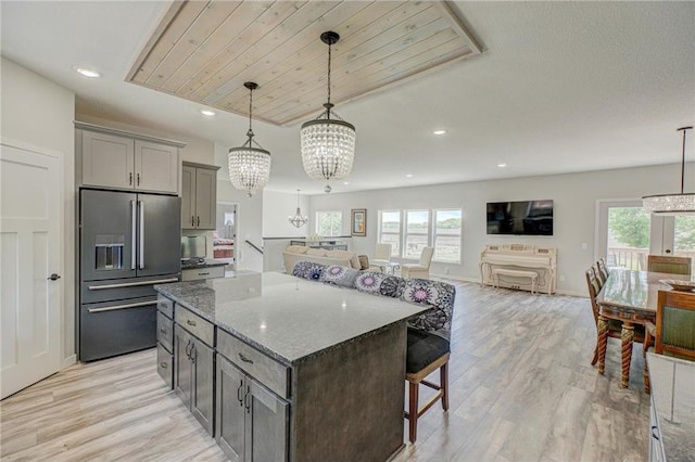 17690 Clayton Ave, Rosemount, MN 55068 - kitchen with high quality fridge, a kitchen breakfast bar, gray cabinetry, a chandelier, and light wood finished floors