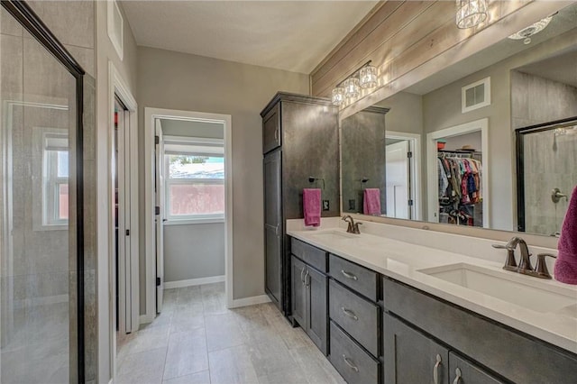17690 Clayton Ave, Rosemount, MN 55068 - bathroom with a spacious closet, double vanity, a tile shower, and baseboards