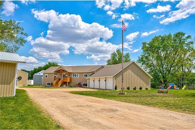 17690 Clayton Ave, Rosemount, MN 55068 - view of front of house featuring driveway, a front lawn, a playground, and board and batten siding