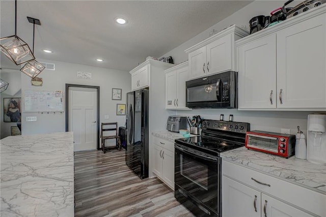 17690 Clayton Ave, Rosemount, MN 55068 - kitchen with black appliances, white cabinetry, recessed lighting, light wood finished floors, and pendant lighting