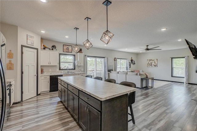 17690 Clayton Ave, Rosemount, MN 55068 - kitchen featuring dishwasher, a kitchen breakfast bar, a sink, white cabinets, and recessed lighting